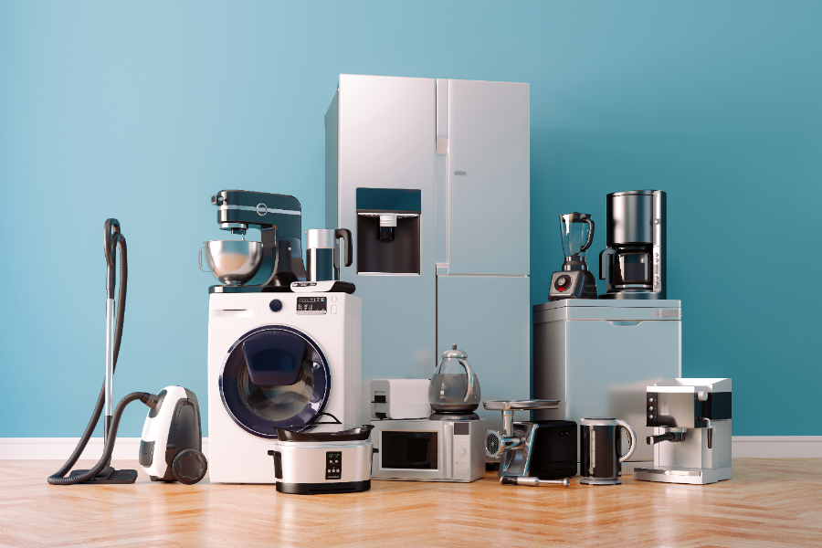 Collection of home appliances including refrigerator, washing machine, vacuum, microwave, and coffee makers arranged against blue background